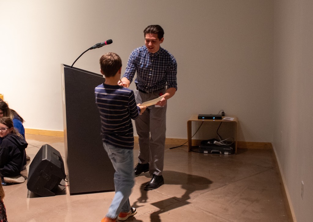 Student standing to receive award for their artwork