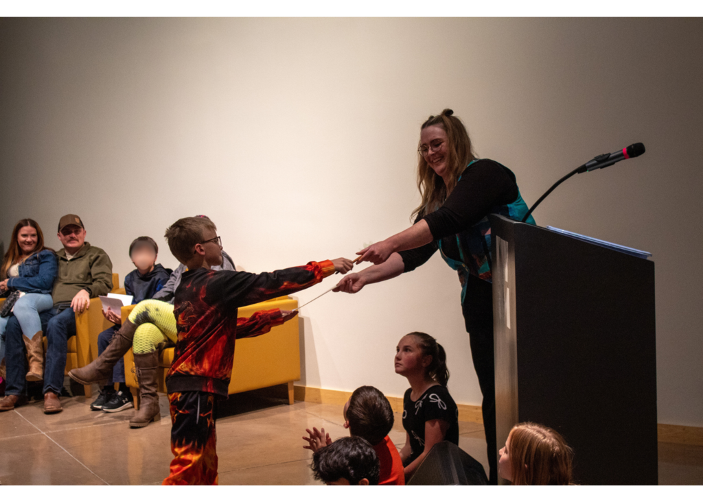 Student standing to receive award for their artwork