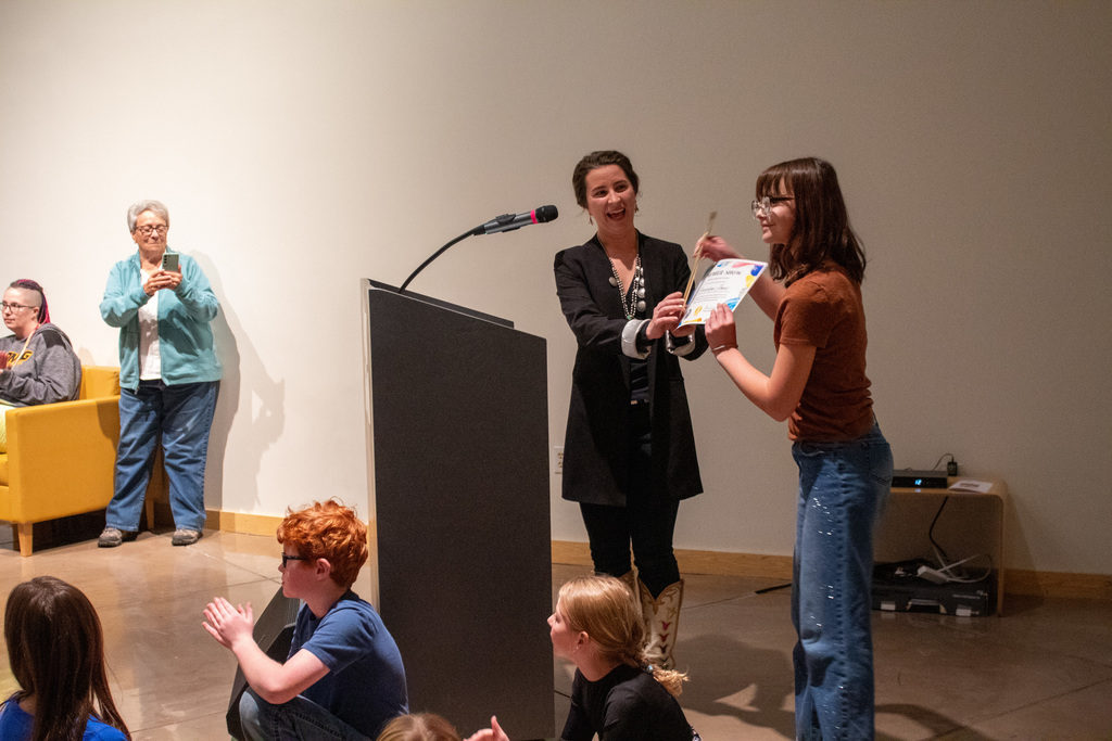 Student standing to receive award for their artwork