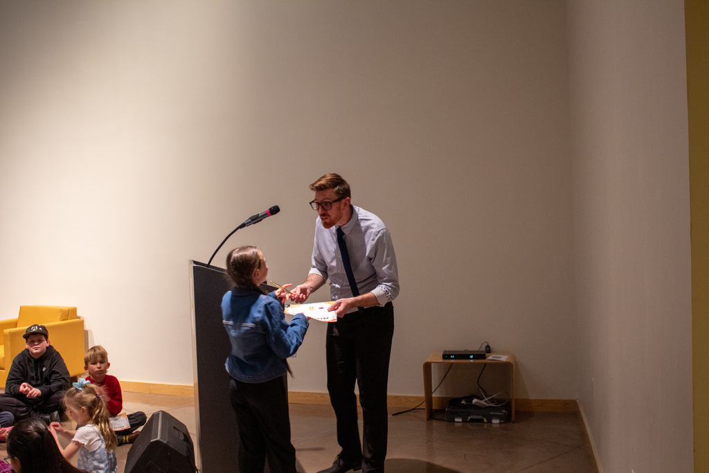 Student standing to receive award for their artwork