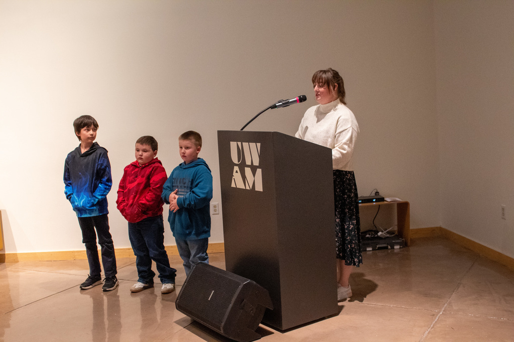 Students standing to receive award for their artwork