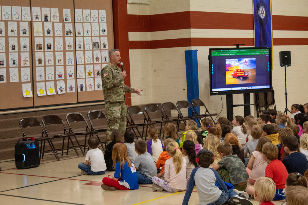 Veteran presenting to students at assembly