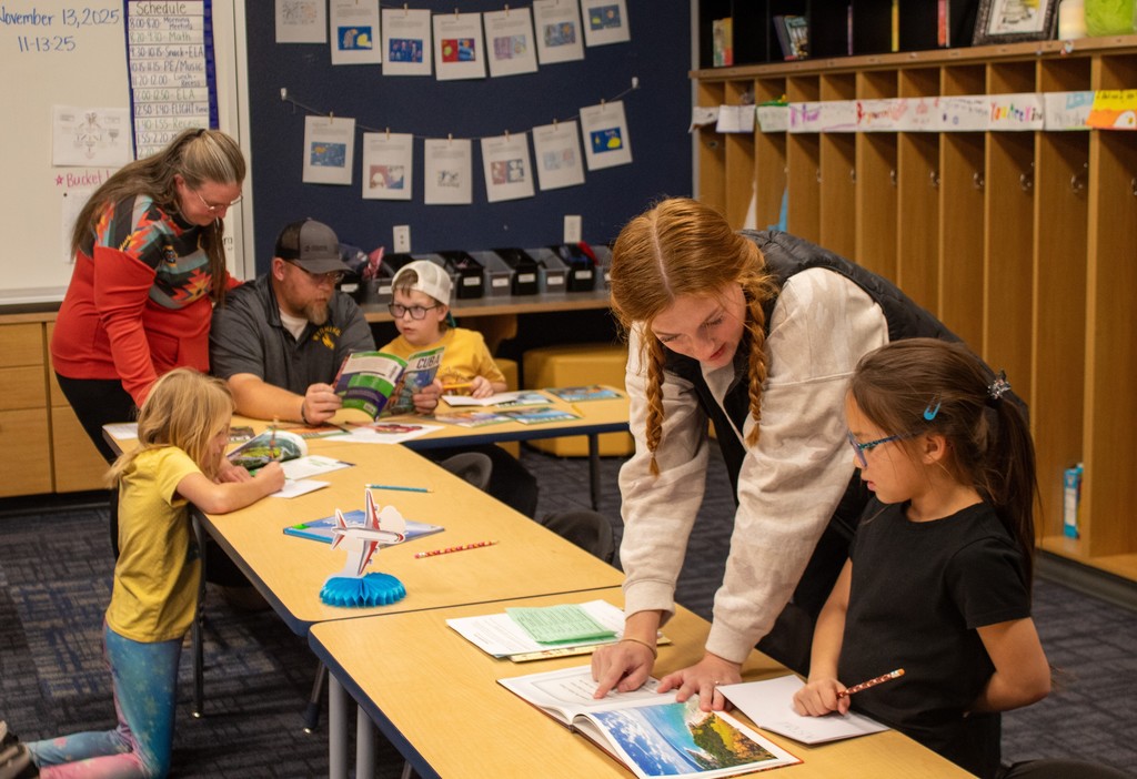 Parents and student working on school work
