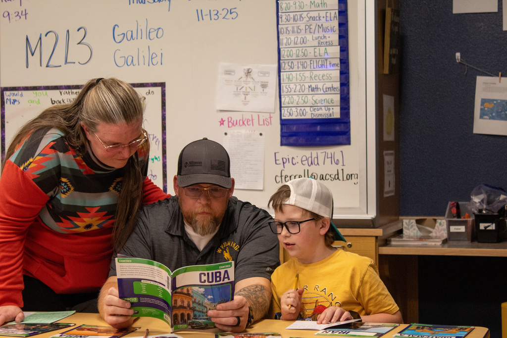 Parents and student working on school work