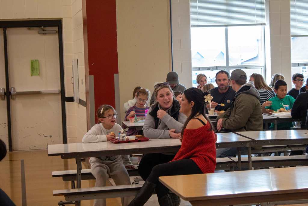Students eating holiday lunch with parents