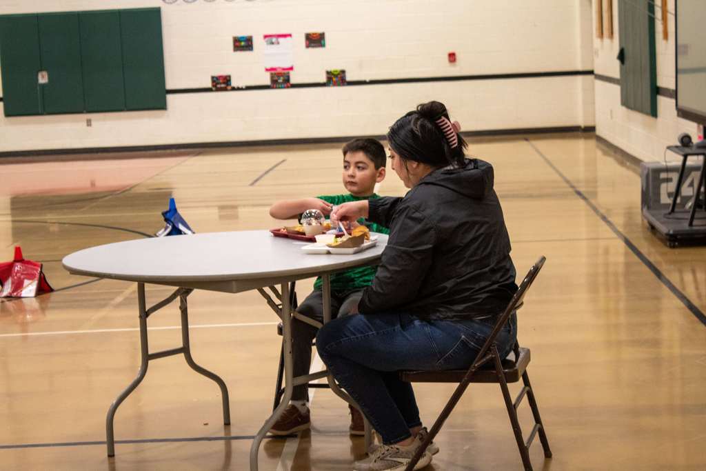 Students eating holiday lunch with parents