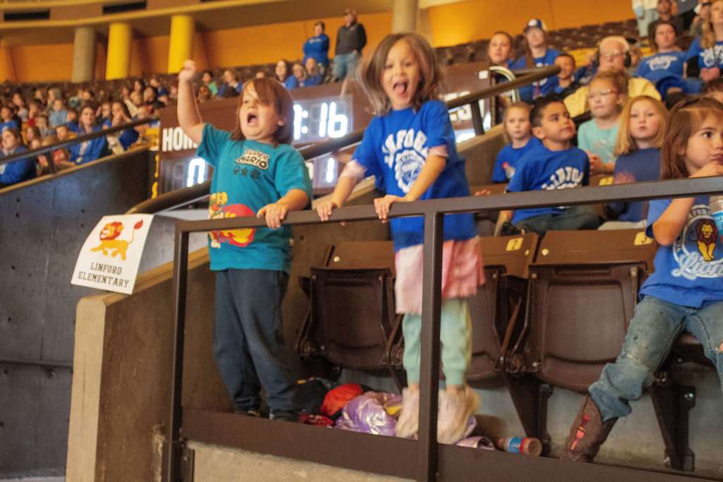 Students sitting in stands watching UW Girls Basketball Game