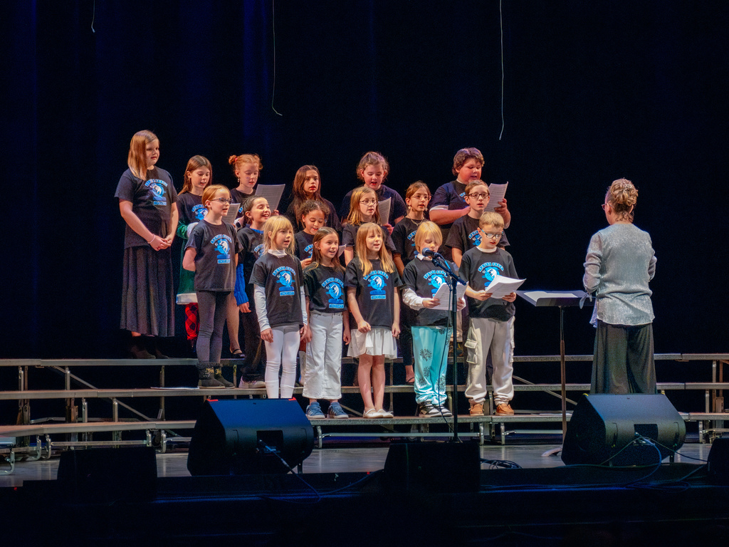student choir singing on a stage