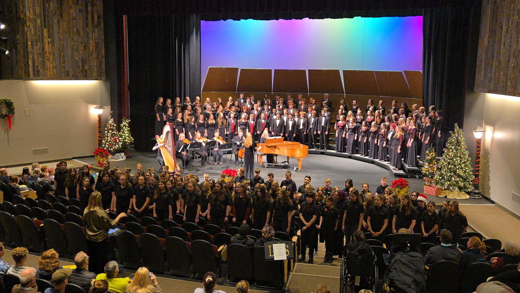 Students in choir singing on stage