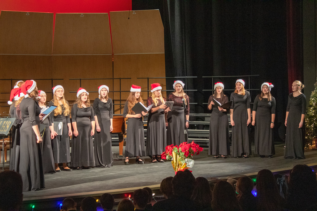 Students in choir singing on stage