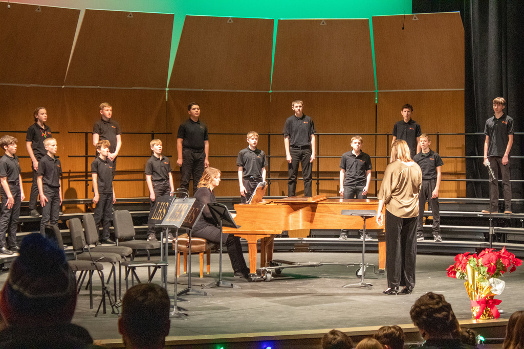 Students in choir singing on stage