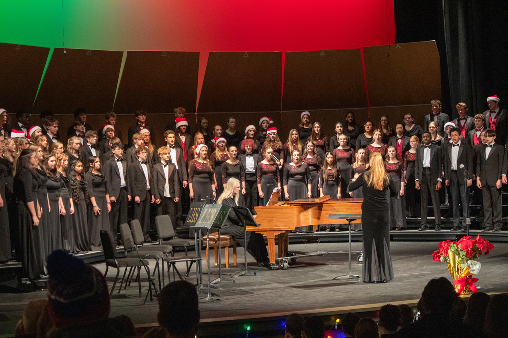 Students in choir singing on stage