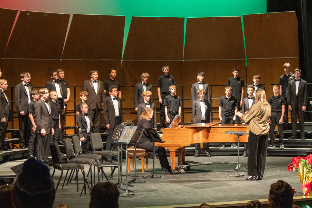 Students in choir singing on stage