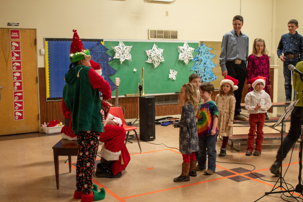 students being visted by santa and elf