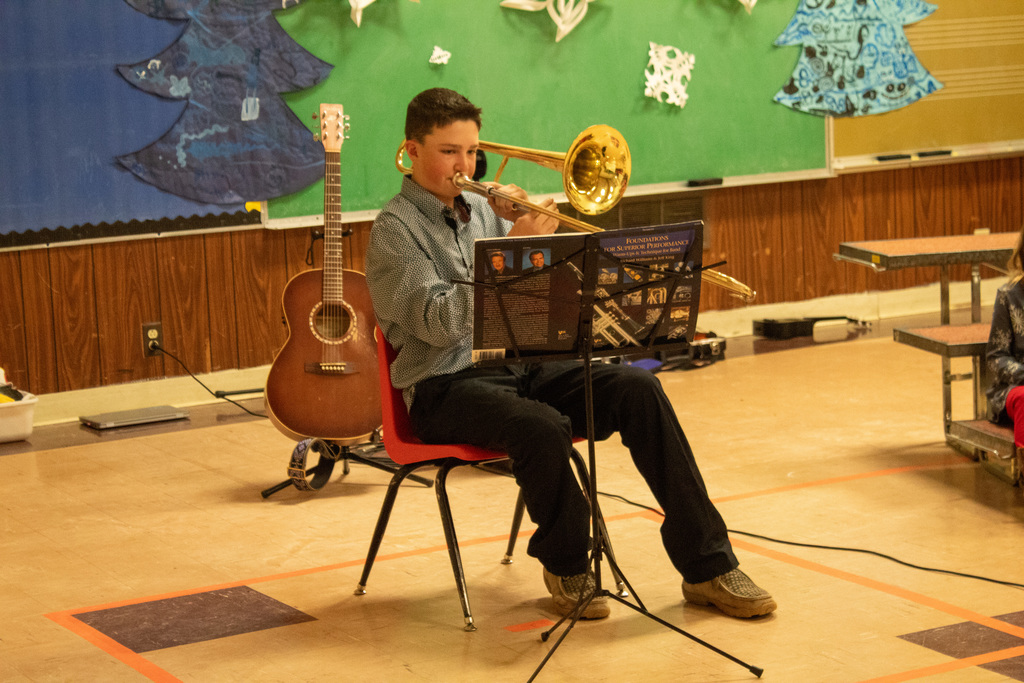 young boy playing trombone