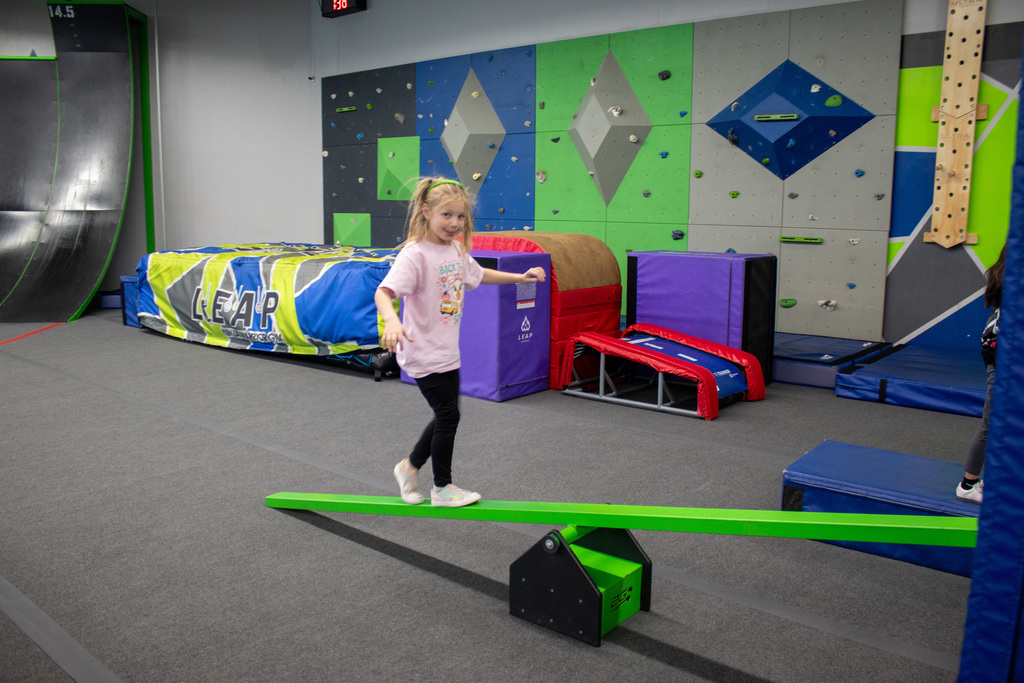 Young student walking on balance beam