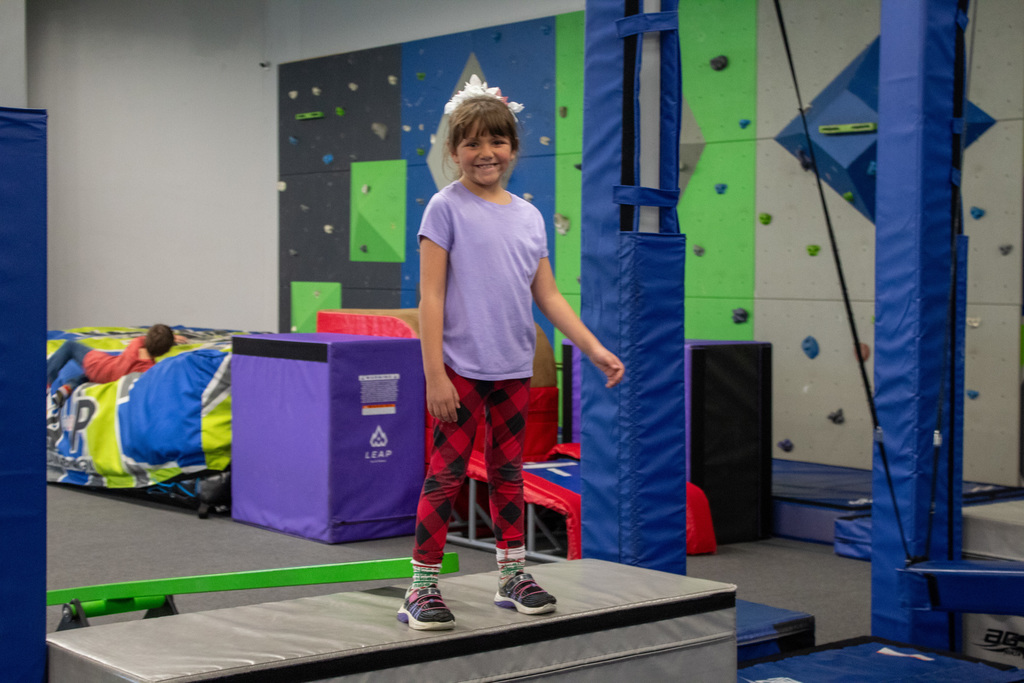 student posing on obstable course