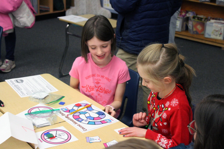 student wokring on math problems with family member