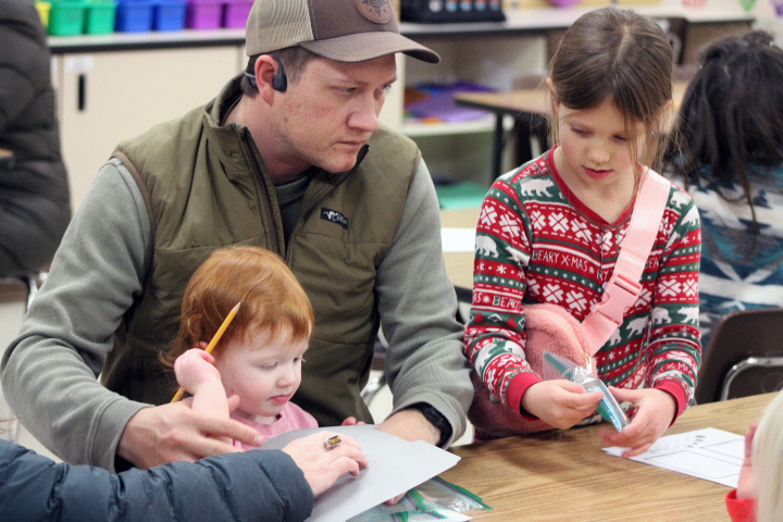 student wokring on math problems with family member