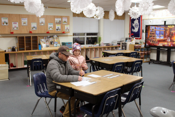 student wokring on math problems with family member