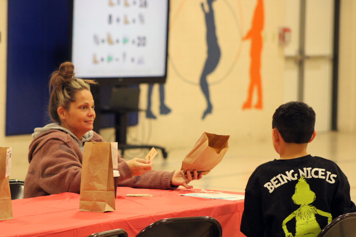 student wokring on math problems with family member
