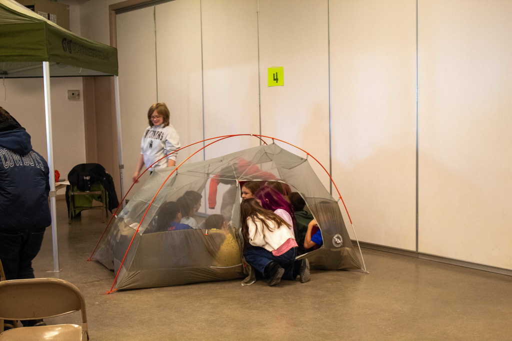 10 students piling into a tent