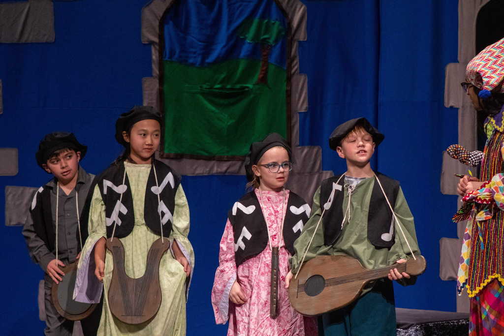 Four students dressed as musicians on stage