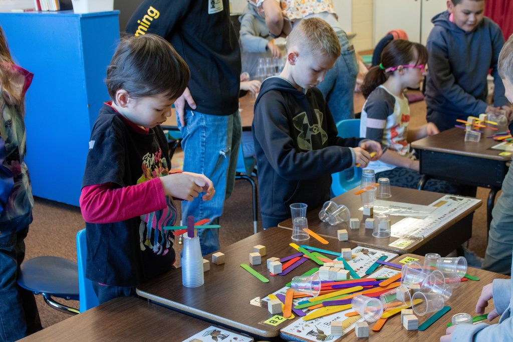 Young boy stacking cups and blocks