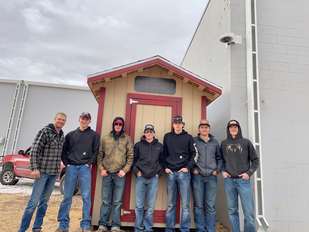 Students standing in front of newly built shed