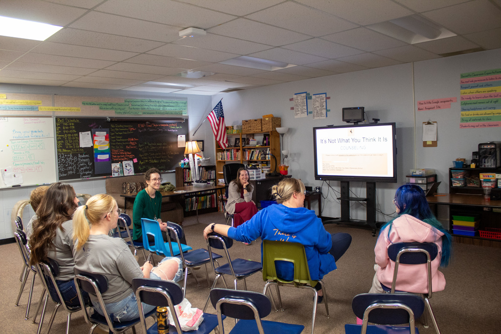 Young women sitting in a circle in a classroom 