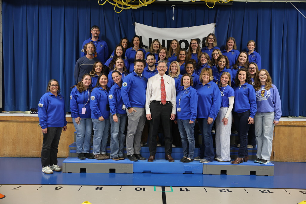Staff standing next to Senator smiling for a picture