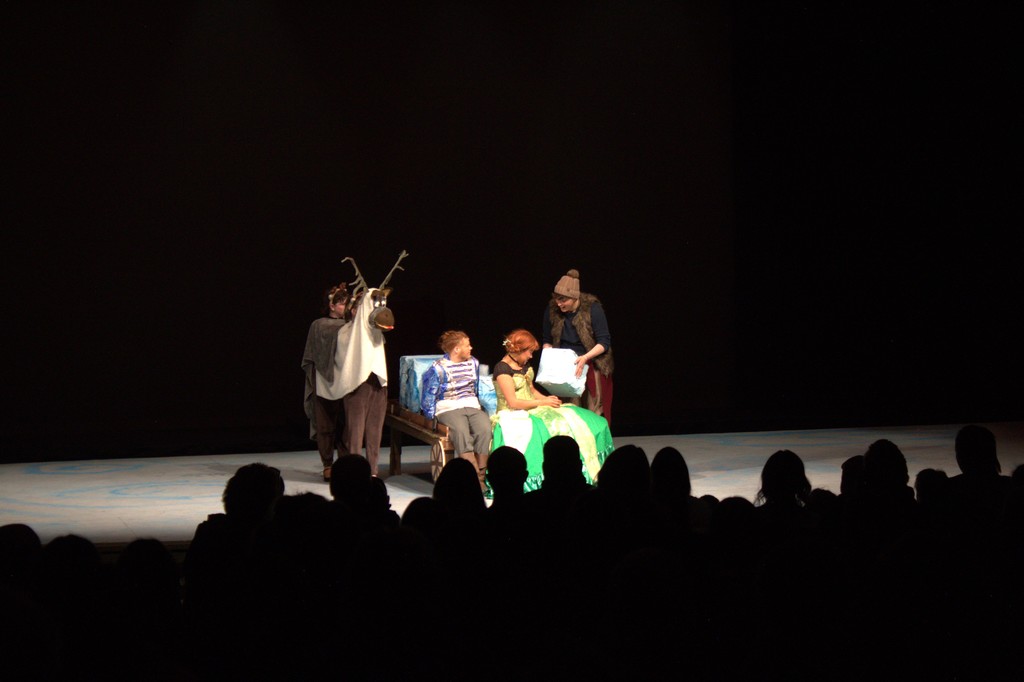 Students sitting on theater props