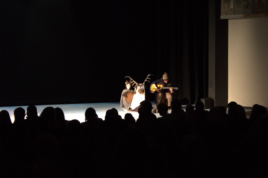 student sitting next to another dressed as  reindeer