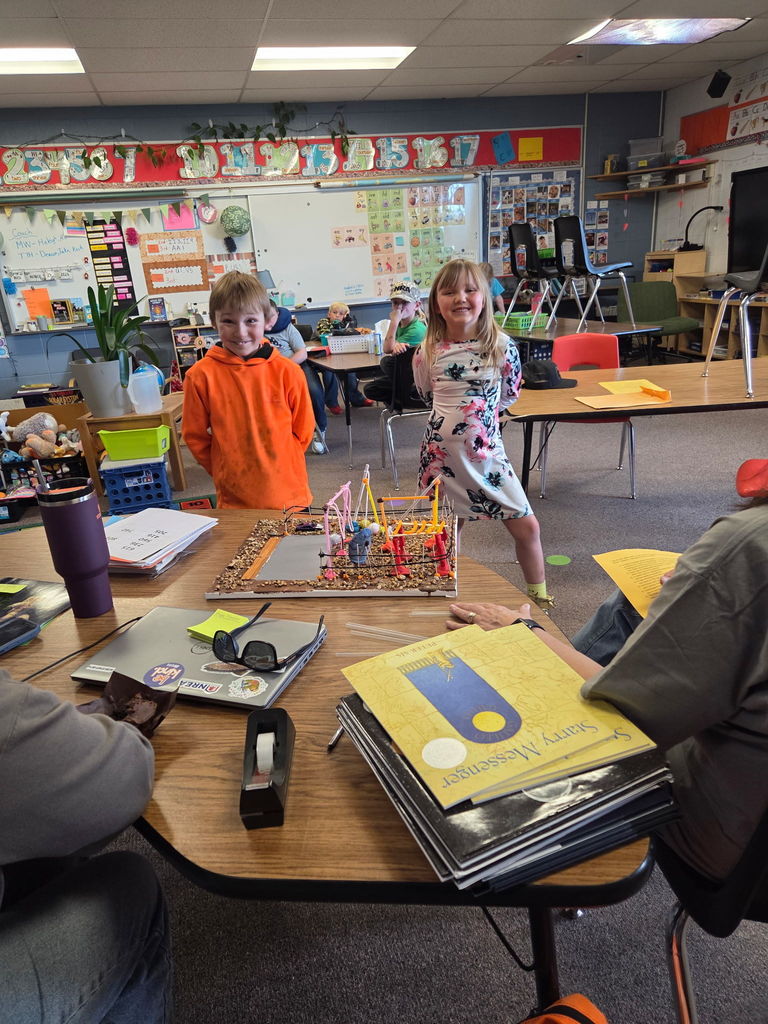 Two students presenting to room full of teachers 