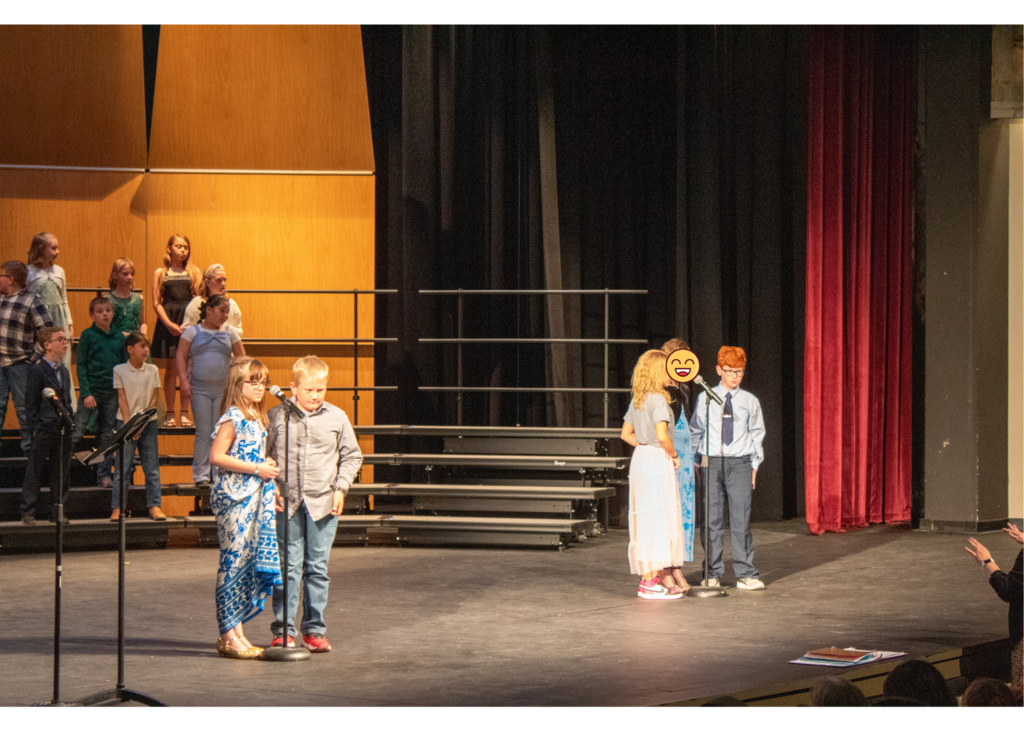 Students standing in front of microphones talking