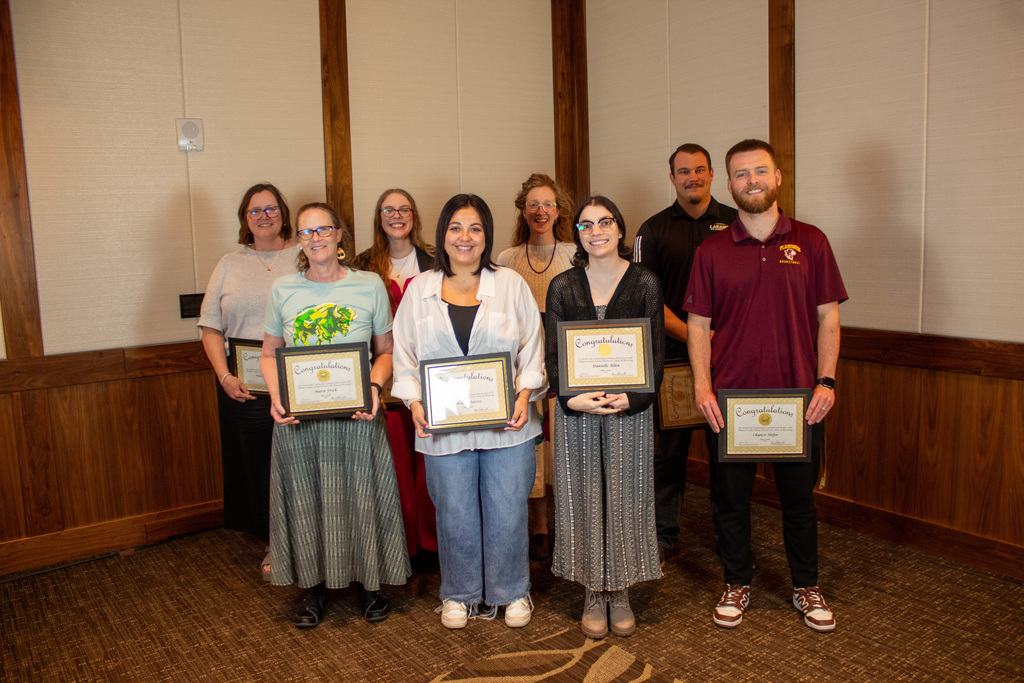 Group of men and women holding certificates