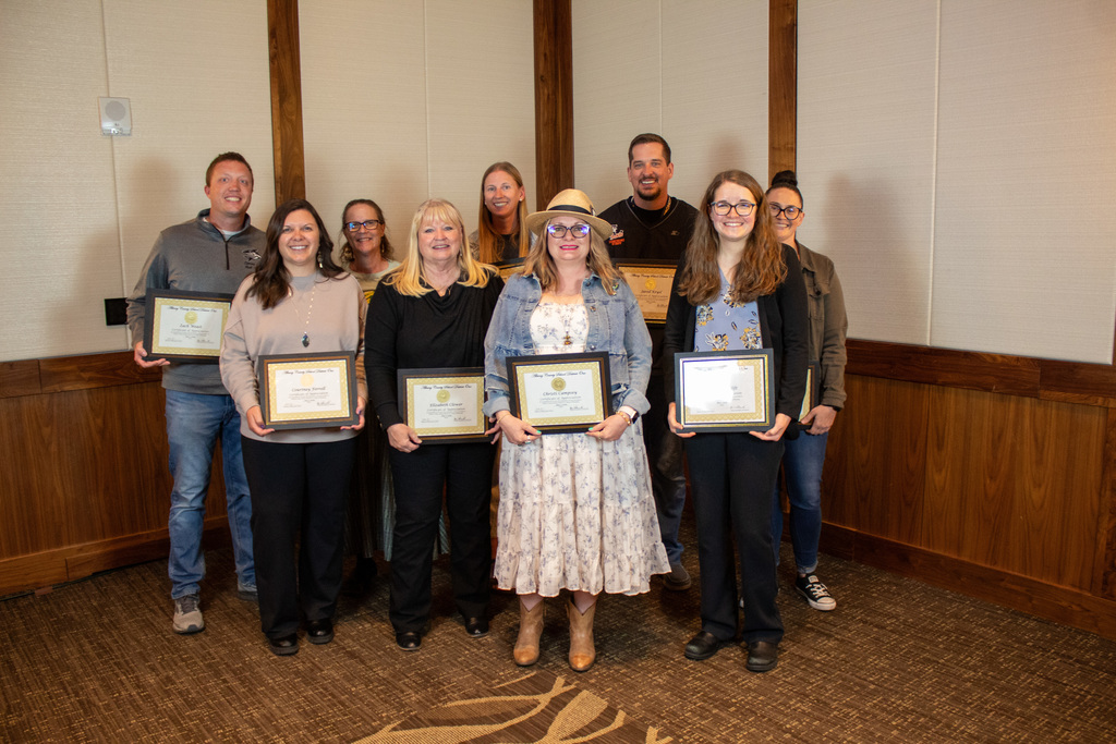 Group of men and women holding certificates 