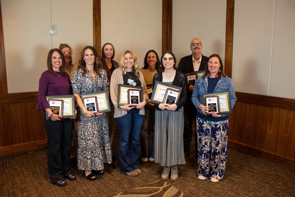 Group of men and women holding certificates 
