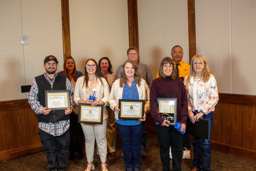 Group of men and women holding certificates 