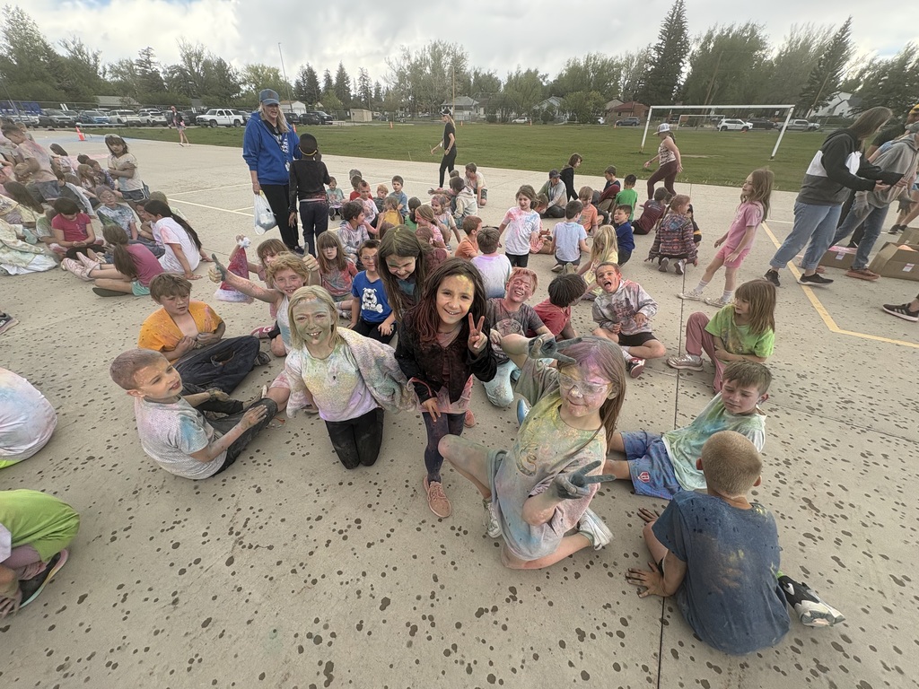 Group of students covered in color from participating in the color run