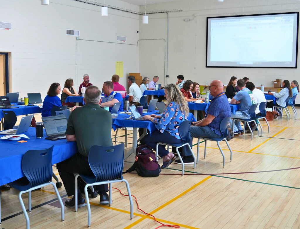 training room with group of people sitting at tables