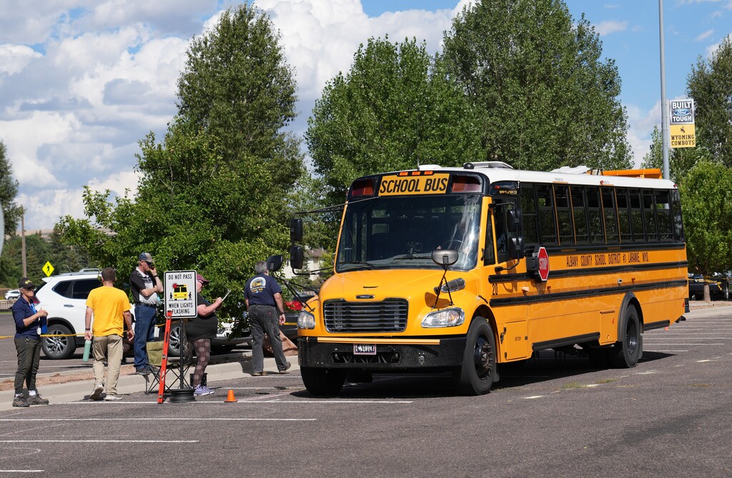 People gathered around a school bus