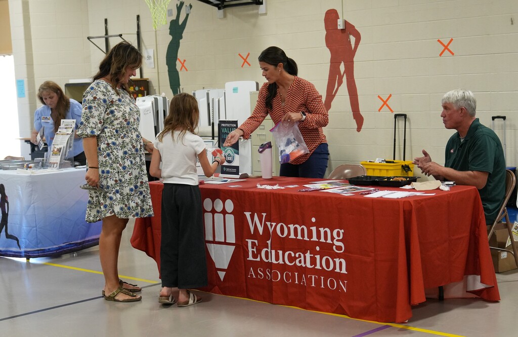 Woman with a young girl interacting with a vendor