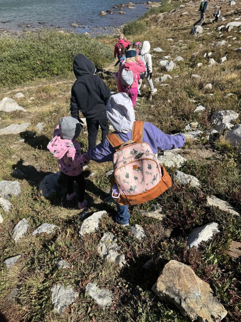 Students hiling down a rocky hill