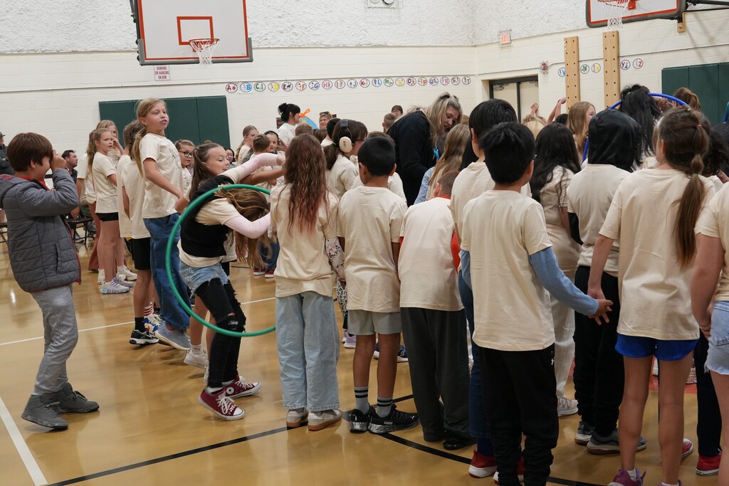students playing a hulahoop game