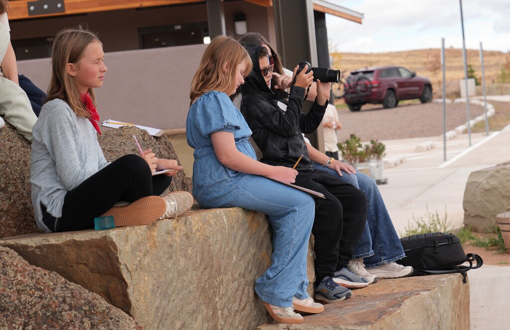 Group of students using a camera to take photographs