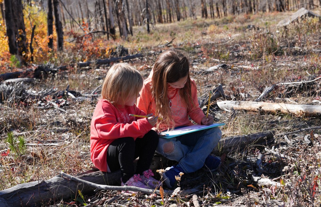 Two young students sitting next to each other
