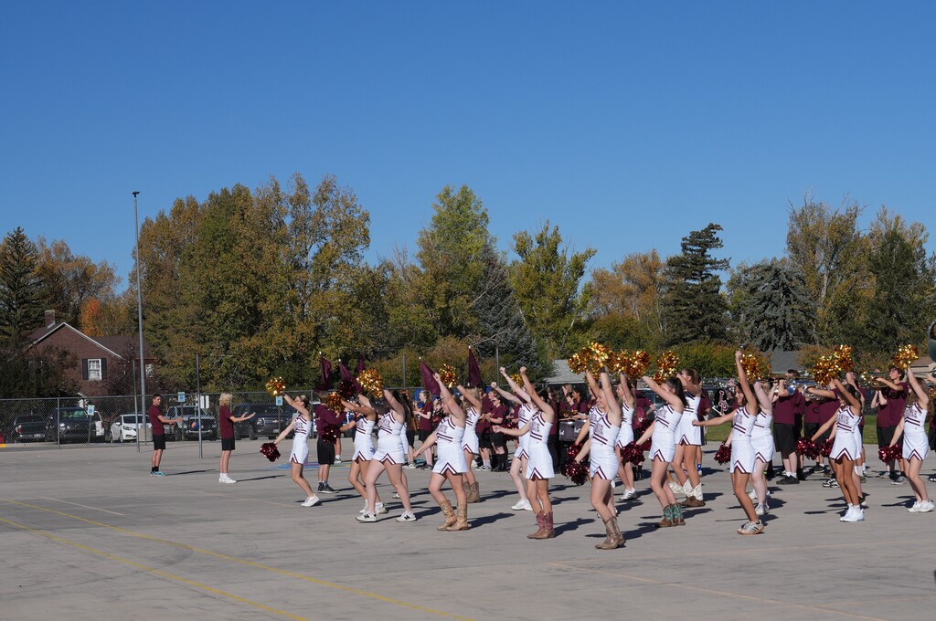 cheerleaders holding poms into the air