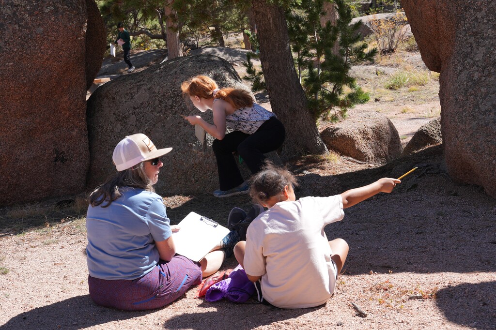 Teacher looking at student pointing out something they see