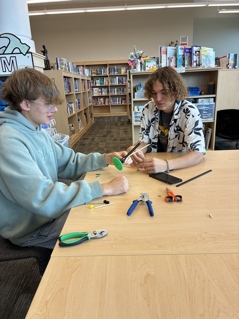 Two stuents building set with tools